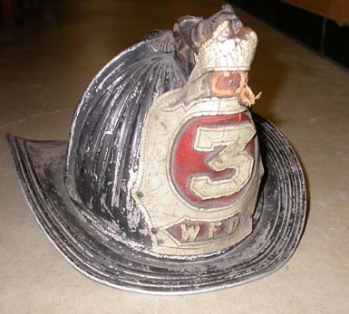 a%20black%20metal%20and%20leather%20fireman%27s%20helmet%20with%20the%20number%203